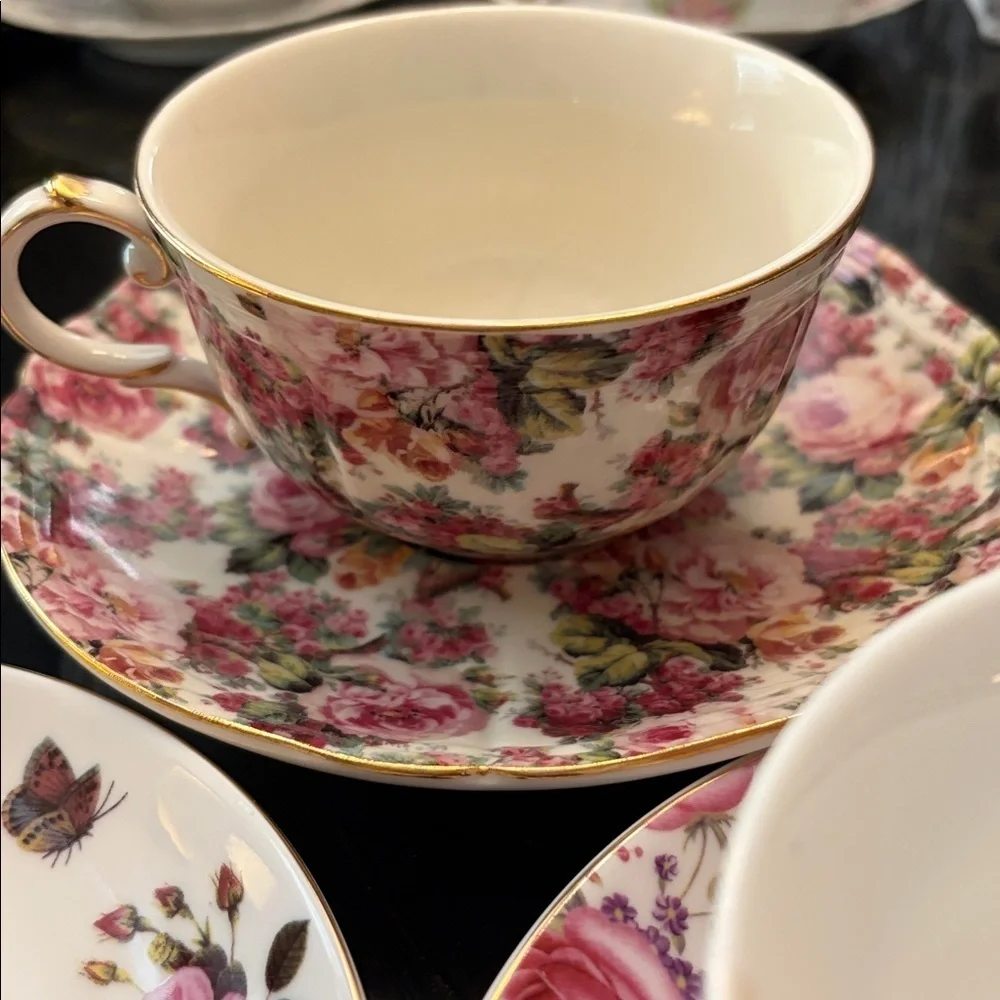 Three modern coordinating cup and saucer sets in shades of pink.